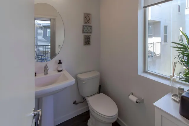 a white toilet sitting next to a bathroom sink