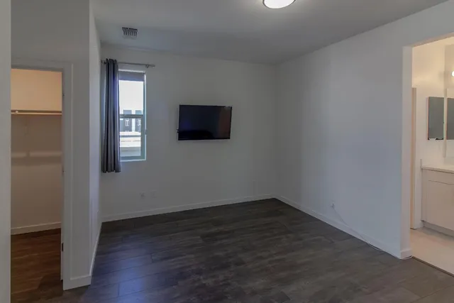 an empty room with wooden floor and a window