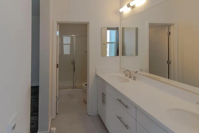 a bathroom with a double vanity sink and mirror