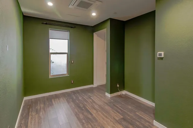 an empty room with closet and window