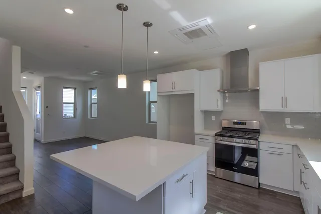 a kitchen with a stove a refrigerator and a sink