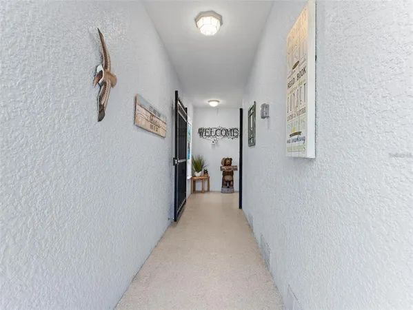 a view of a hallway with paintings on the wall