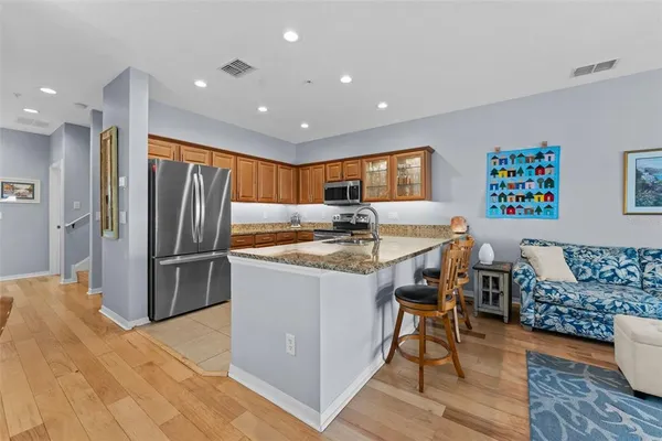 a kitchen with large windows and refrigerator