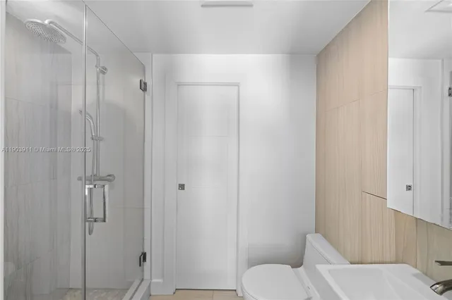a bathroom with a toilet and a shower