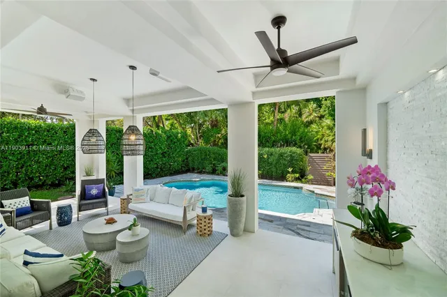 a living room with furniture and floor to ceiling windows