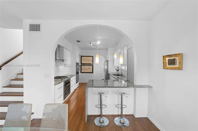 a view of kitchen with furniture and wooden floor