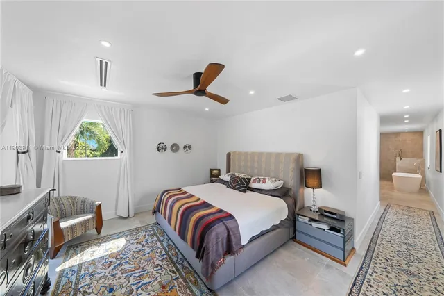 a bedroom with bed and a window