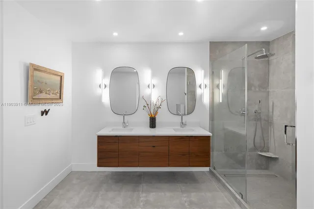 a bathroom with double vanity sinks a toilet a glass door and shower