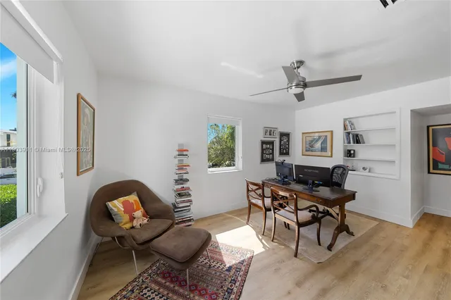 a workspace with wooden floor and a window