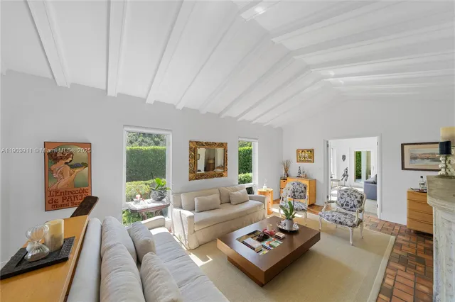 a living room with furniture couches and a flat screen tv