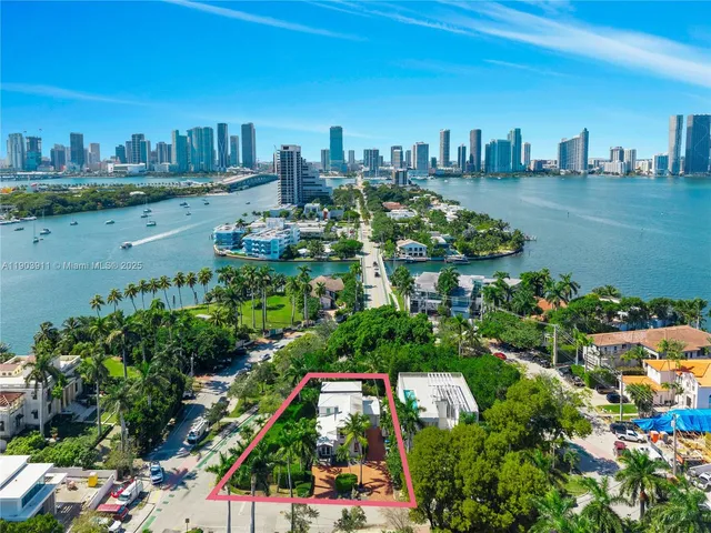 a view of a lake with lawn chairs and wooden fence