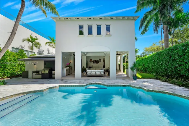 a view of a house with backyard porch and sitting area