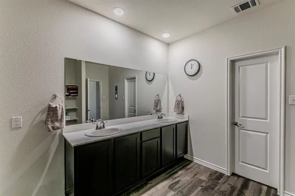 a bathroom with a double vanity sink and a mirror
