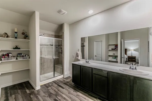 a bathroom with a double vanity sink and a mirror