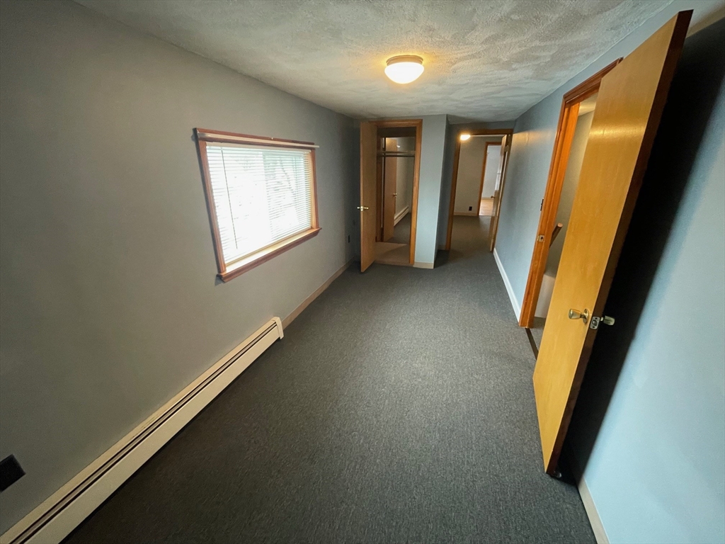 39 Franklin Street, Unit R Woburn, MA 01801 - Photo 11 of 18 a view of a hallway with windows