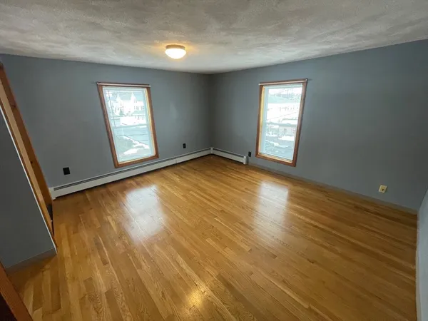 a view of an empty room and wooden floor