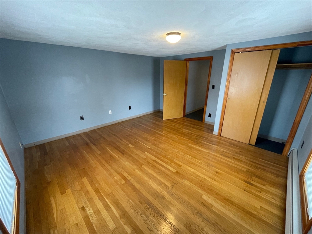 39 Franklin Street, Unit R Woburn, MA 01801 - Photo 16 of 18 a view of an empty room and wooden floor