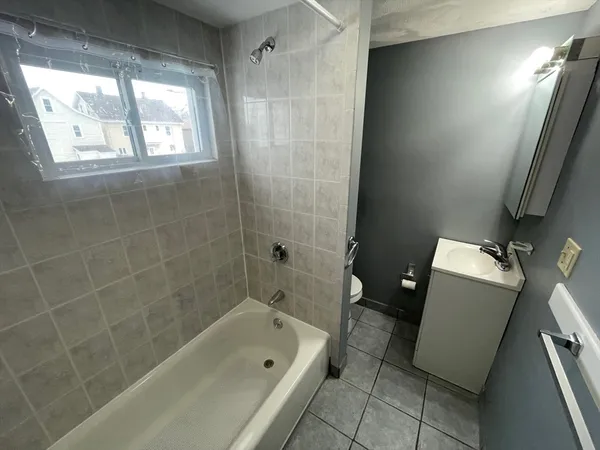 a bathroom with a tub a sink and a toilet