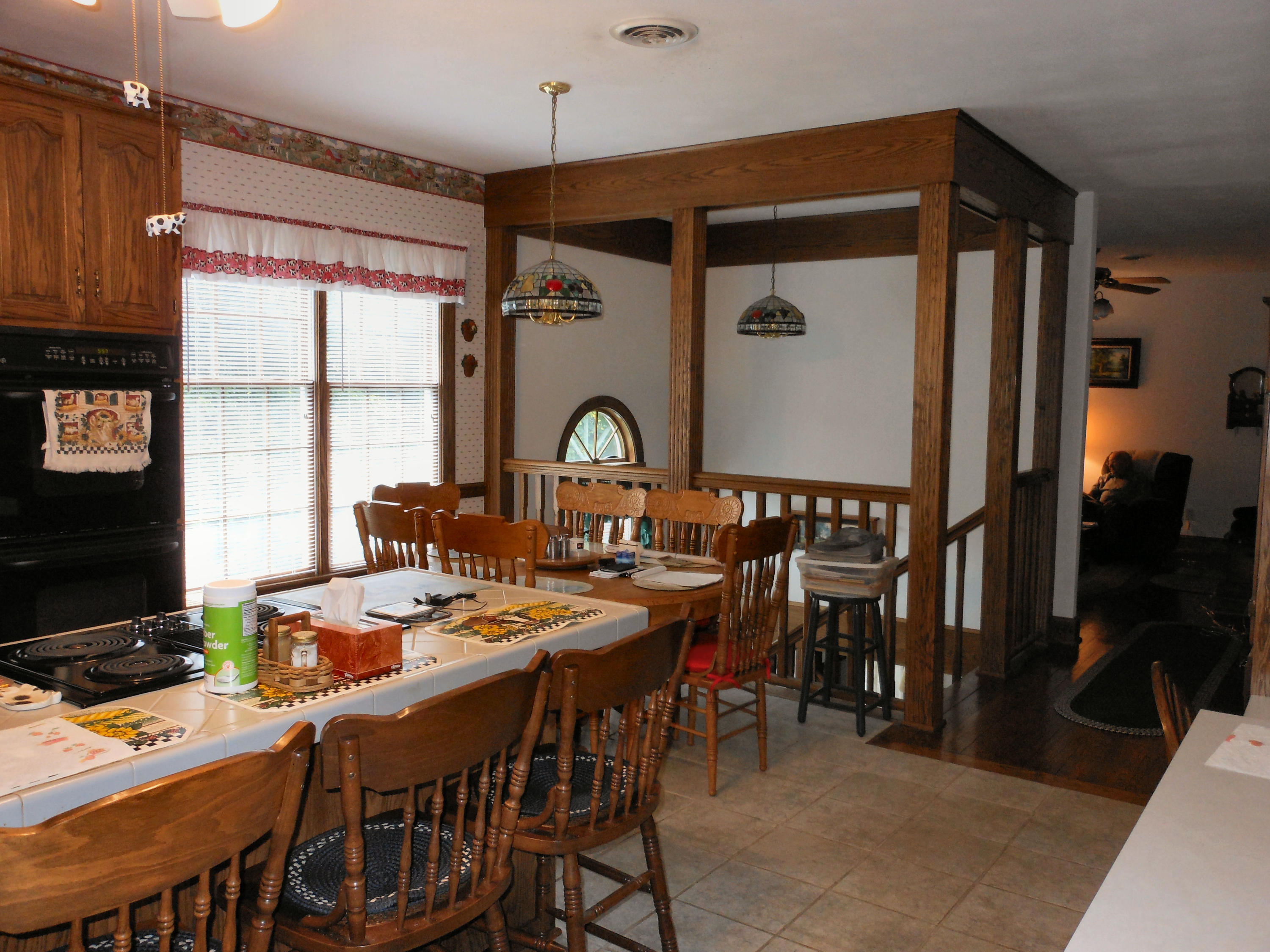 4019 Goodview Road Goodview, VA 24095 - Photo 19 of 47 a dining hall with stainless steel appliances kitchen island granite countertop a table chairs and a wooden floor