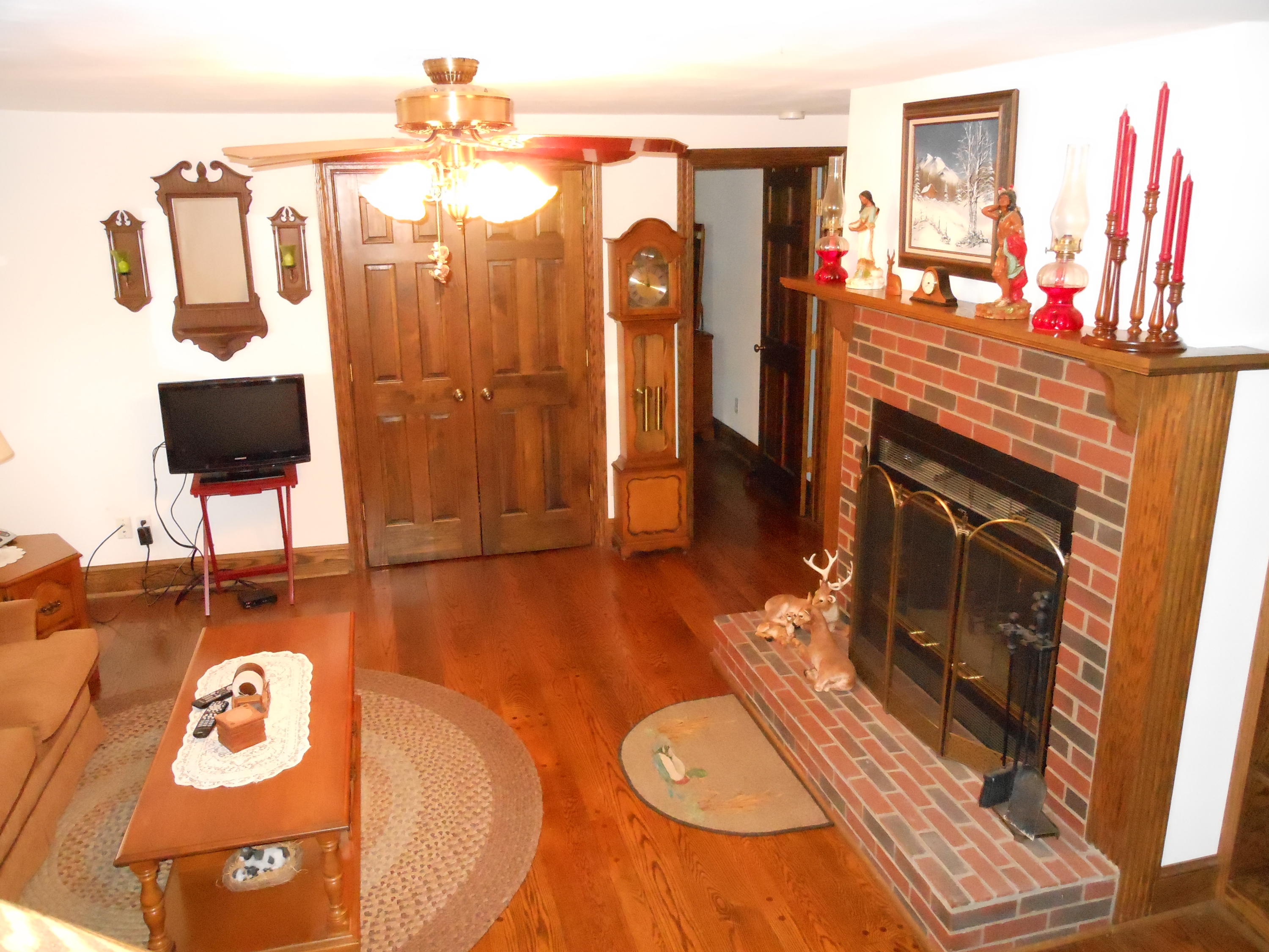4019 Goodview Road Goodview, VA 24095 - Photo 35 of 47 a living room with furniture a flat screen tv and a fireplace