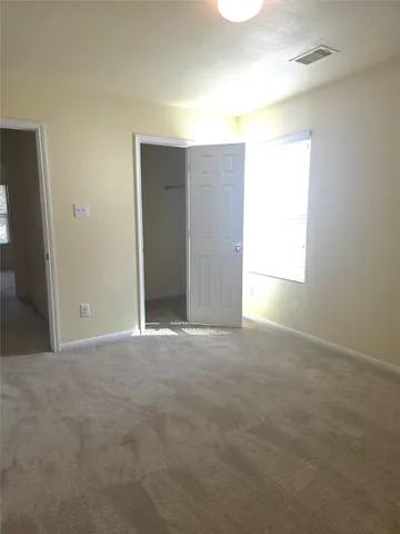 an empty room with windows and closet