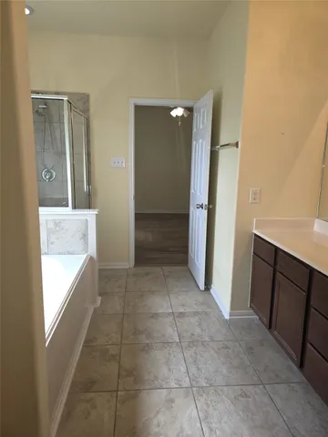 a view of hallway with a sink and a mirror