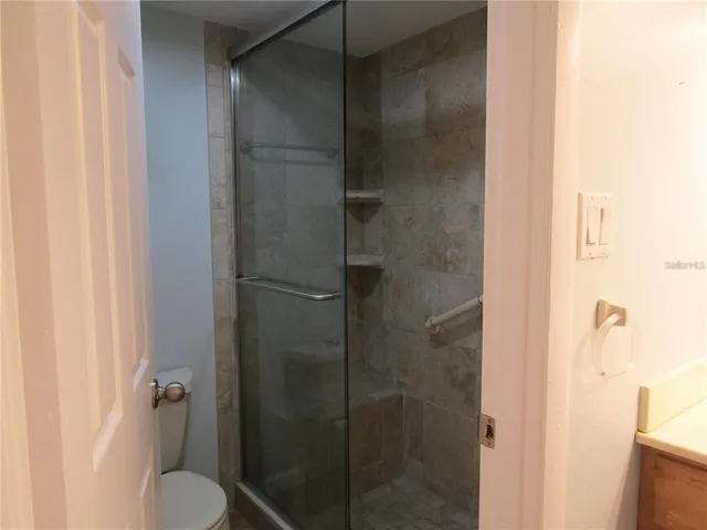 a bathroom with a shower and toilet