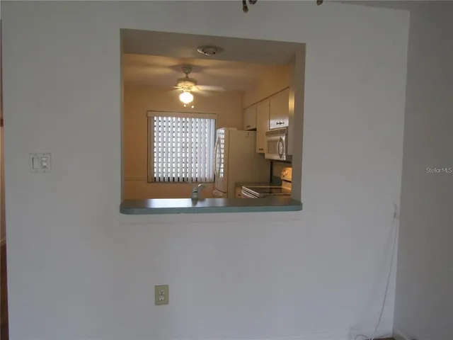 a view of a hallway with wooden shelves