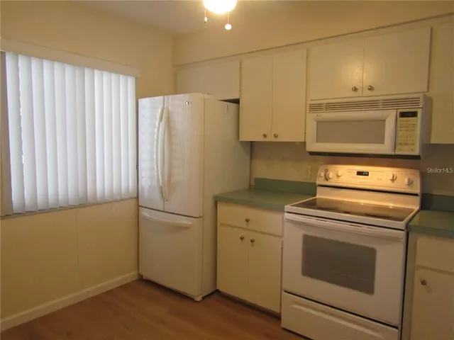 a kitchen with a stove microwave and refrigerator