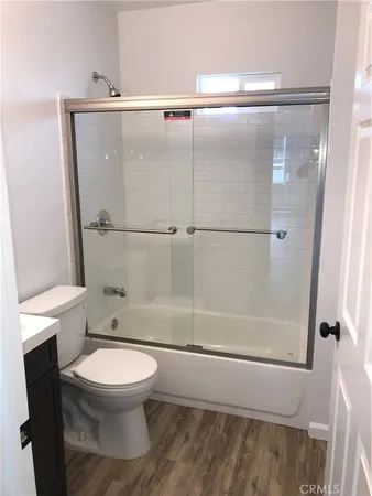 a white toilet sitting next to a bathroom sink