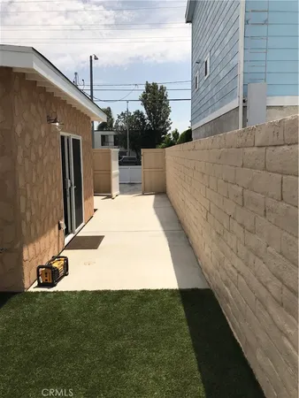 a view of backyard with barbeque grill and plants