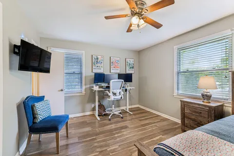 a work room with furniture and a flat screen tv