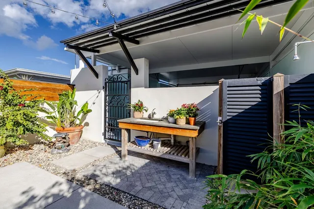 a backyard of a house with outdoor seating