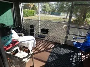 a view of a patio with table and chairs and potted plants