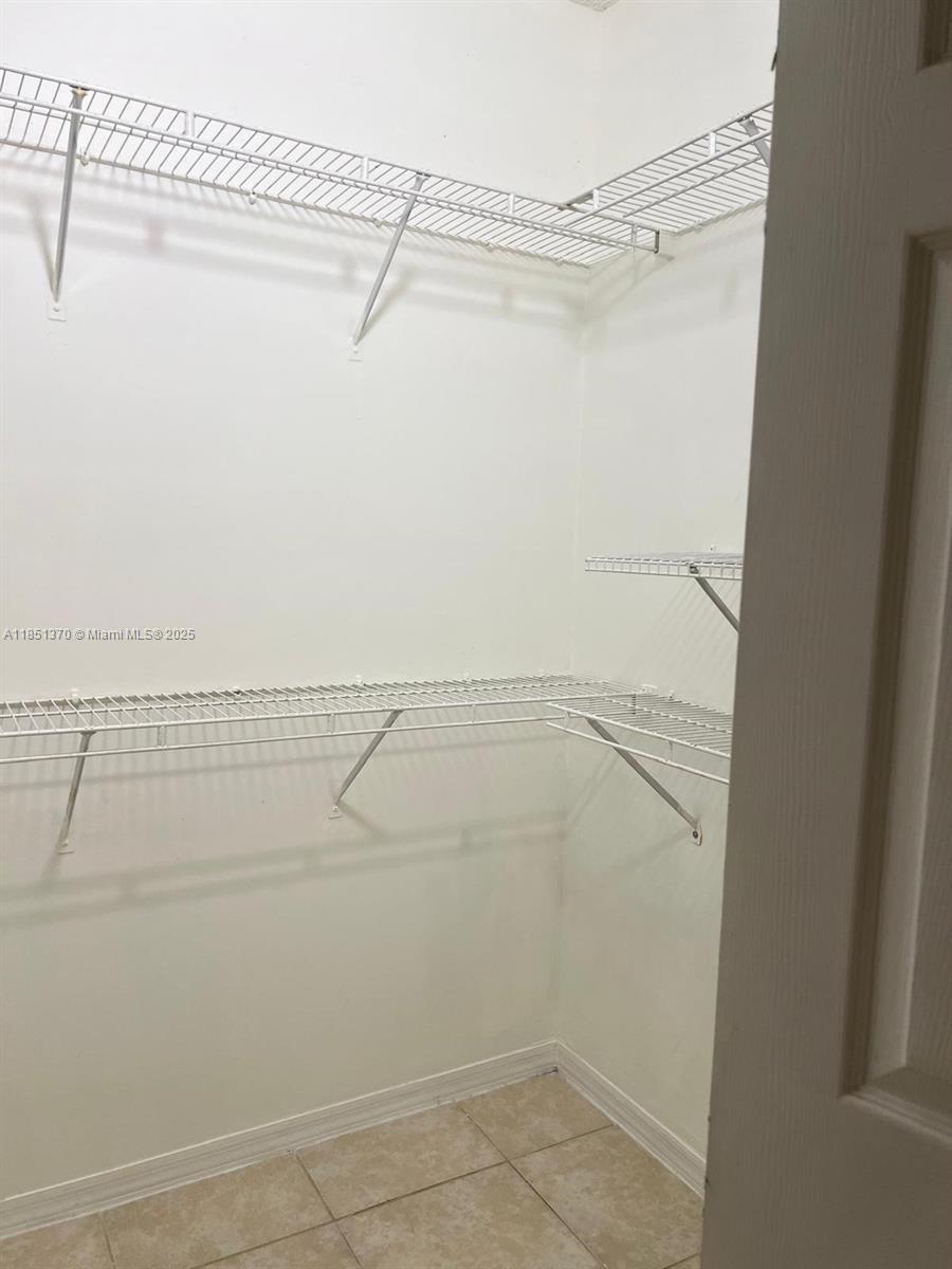 9645 Northwest 1st Court, Unit 1209 Pembroke Pines, FL 33024 - Photo 12 of 70 a view of a room with racks on the wall