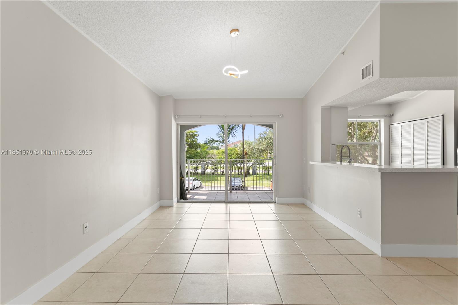 9645 Northwest 1st Court, Unit 1209 Pembroke Pines, FL 33024 - Photo 25 of 70 a view of an empty room with a window