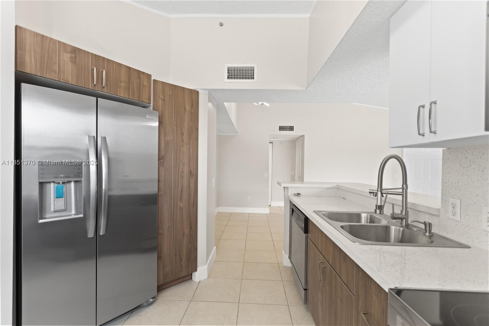 9645 Northwest 1st Court, Unit 1209 Pembroke Pines, FL 33024 - Photo 36 of 70 a kitchen with stainless steel appliances granite countertop a refrigerator and a sink