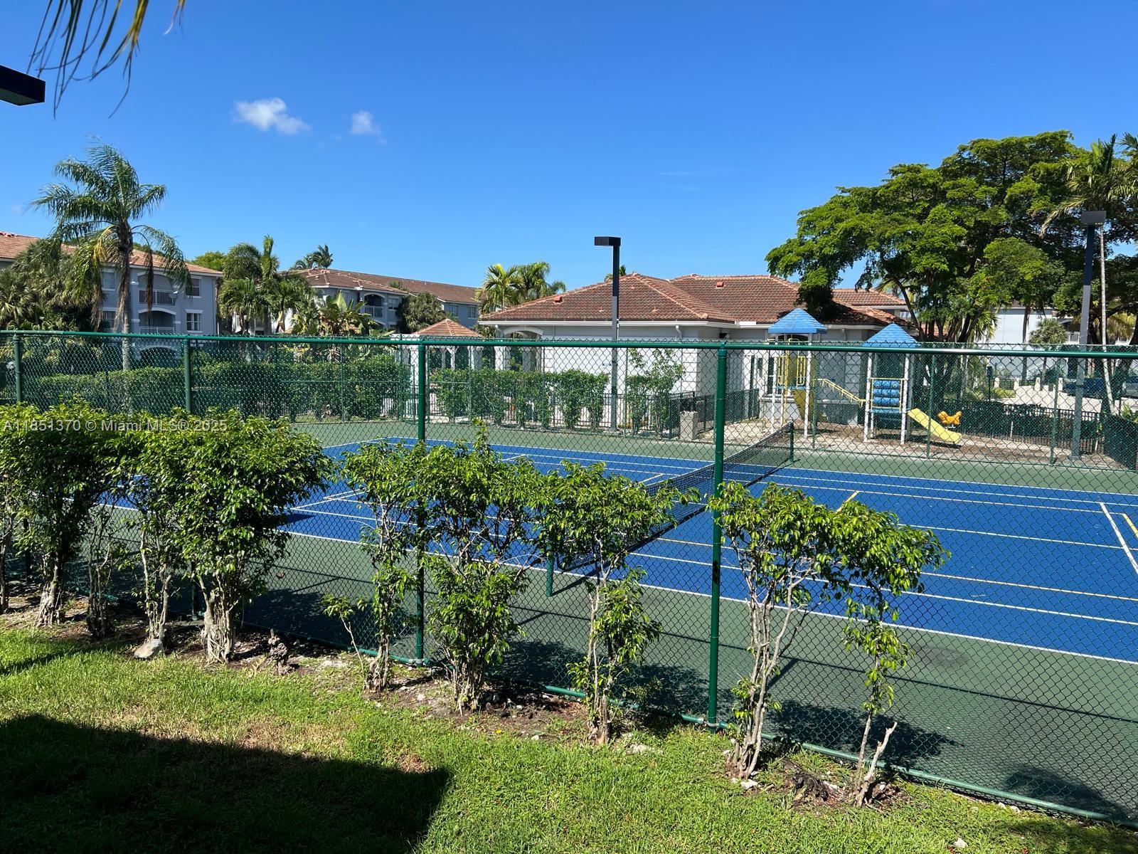 9645 Northwest 1st Court, Unit 1209 Pembroke Pines, FL 33024 - Photo 4 of 70 a front view of a house with a yard