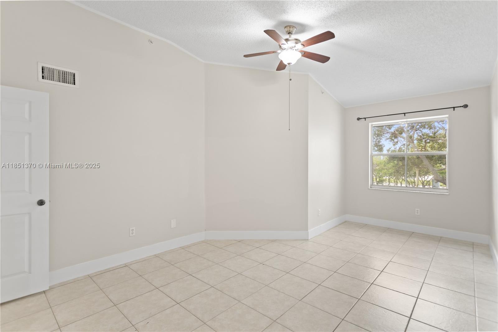 9645 Northwest 1st Court, Unit 1209 Pembroke Pines, FL 33024 - Photo 49 of 70 an empty room with chandelier fan and windows