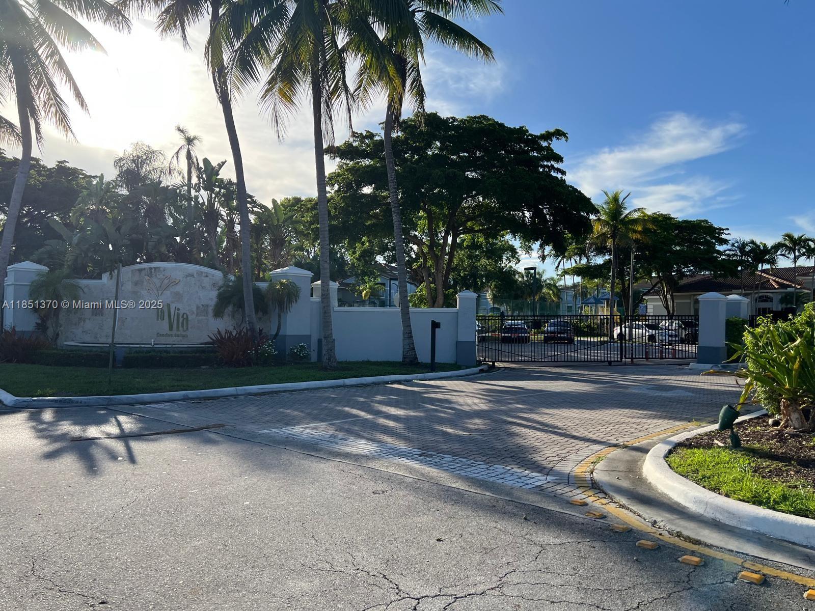9645 Northwest 1st Court, Unit 1209 Pembroke Pines, FL 33024 - Photo 5 of 70 a view of a bench in a yard