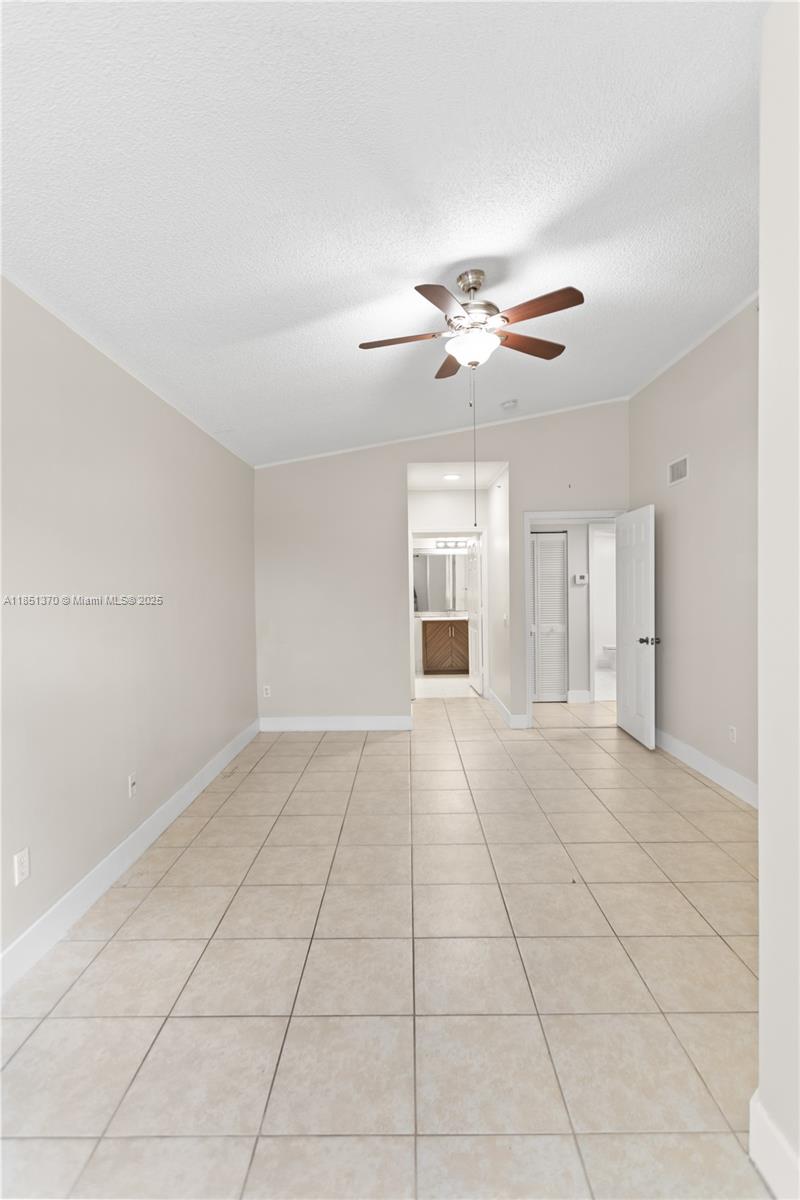 9645 Northwest 1st Court, Unit 1209 Pembroke Pines, FL 33024 - Photo 53 of 70 a view of an empty room with a ceiling fan and a window