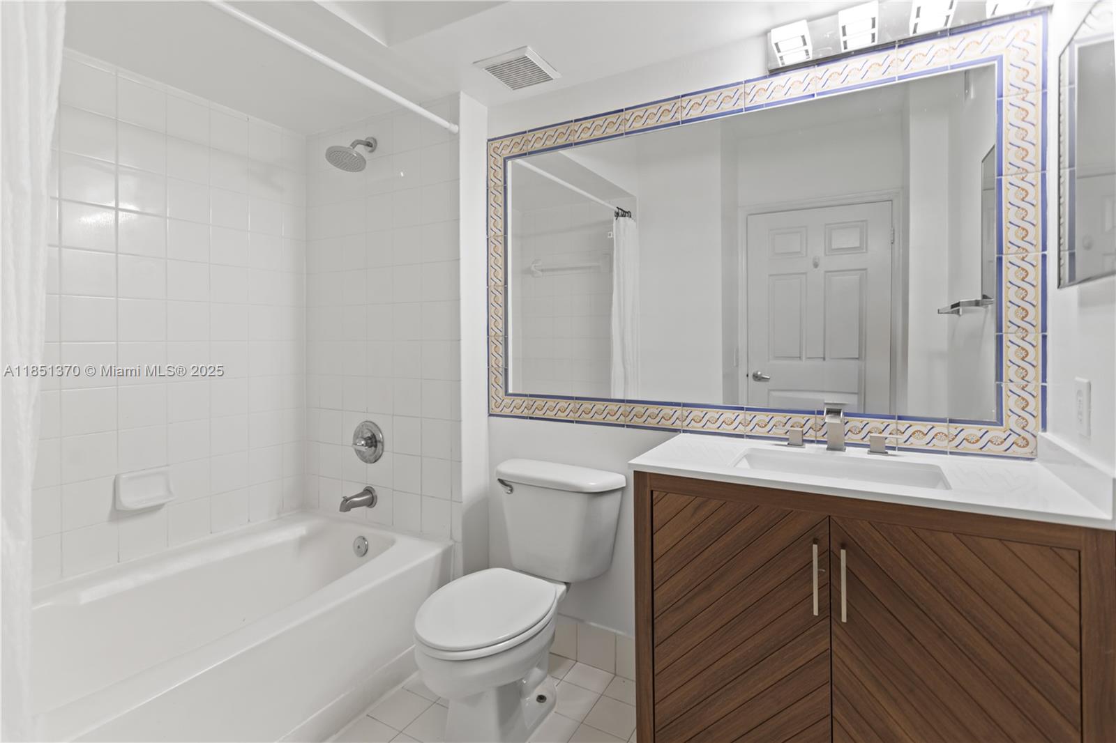 9645 Northwest 1st Court, Unit 1209 Pembroke Pines, FL 33024 - Photo 55 of 70 a bathroom with a sink toilet vanity and shower