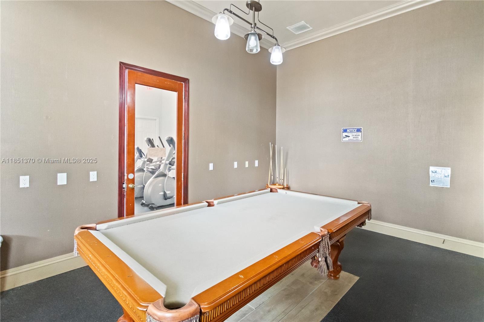 9645 Northwest 1st Court, Unit 1209 Pembroke Pines, FL 33024 - Photo 67 of 70 a room with pool table and a chandelier