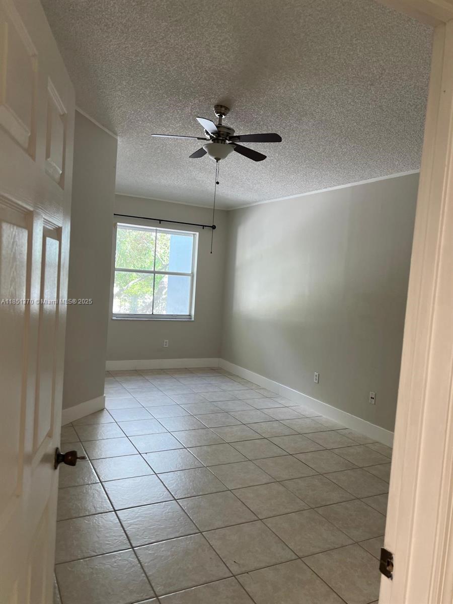 9645 Northwest 1st Court, Unit 1209 Pembroke Pines, FL 33024 - Photo 8 of 70 an empty room with windows and fan