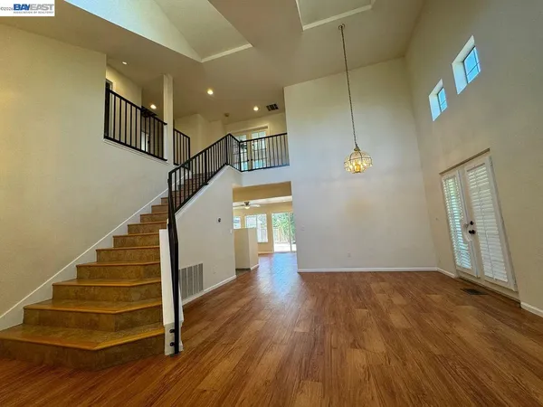 a view of an empty room with a ceiling fan