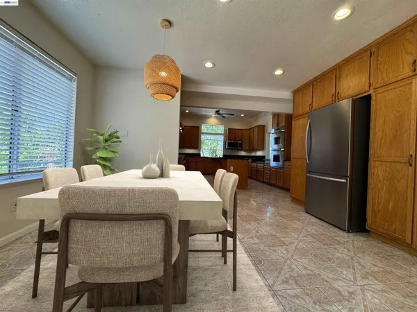 a view of a backyard with plants and wooden fence