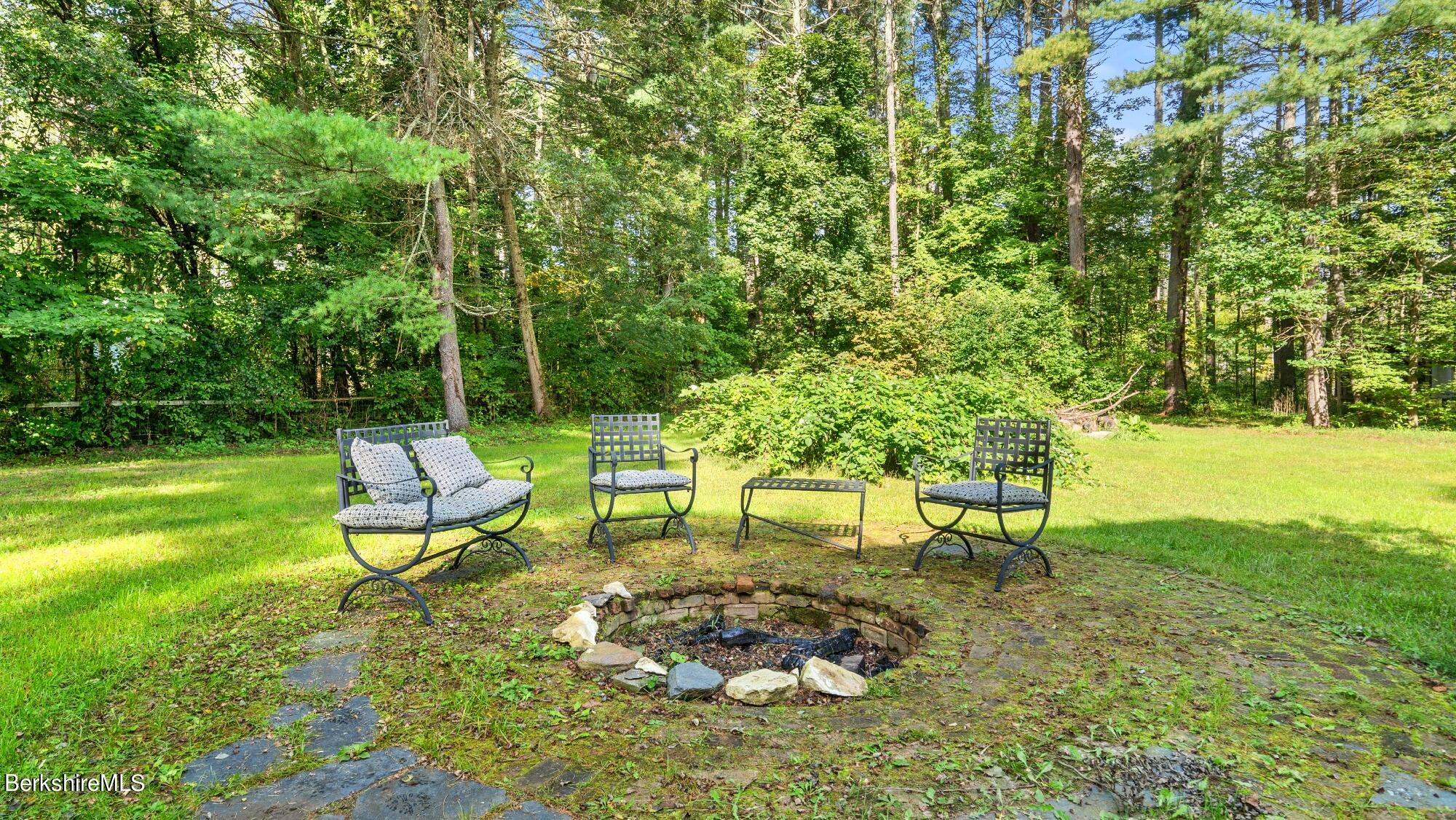 508 Polikoff Road Sheffield, MA 01222 - Photo 9 of 28 a view of a bench in the garden near a lake