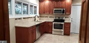 a kitchen with a sink stove and microwave
