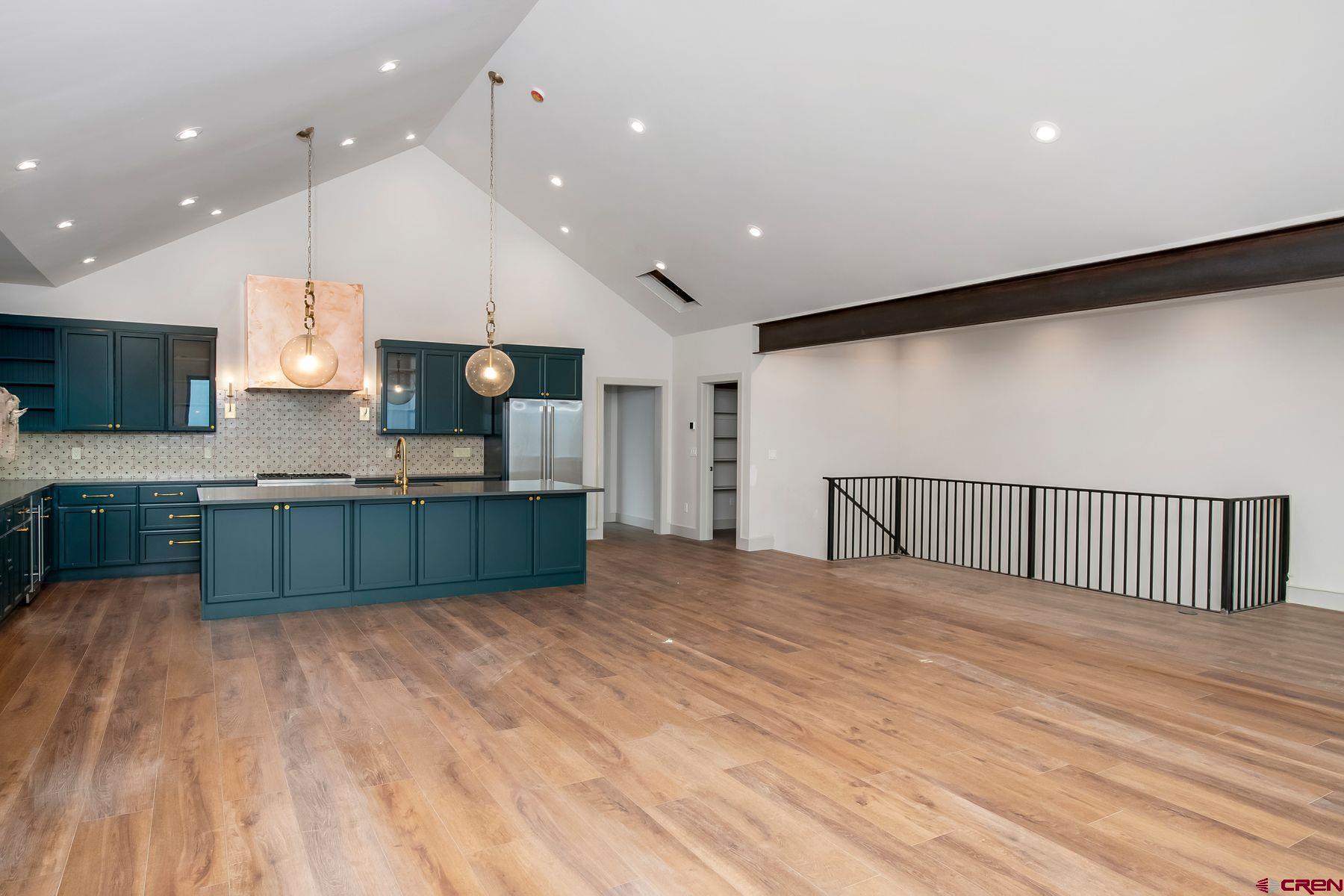 a large kitchen with kitchen island a sink stainless steel appliances and cabinets