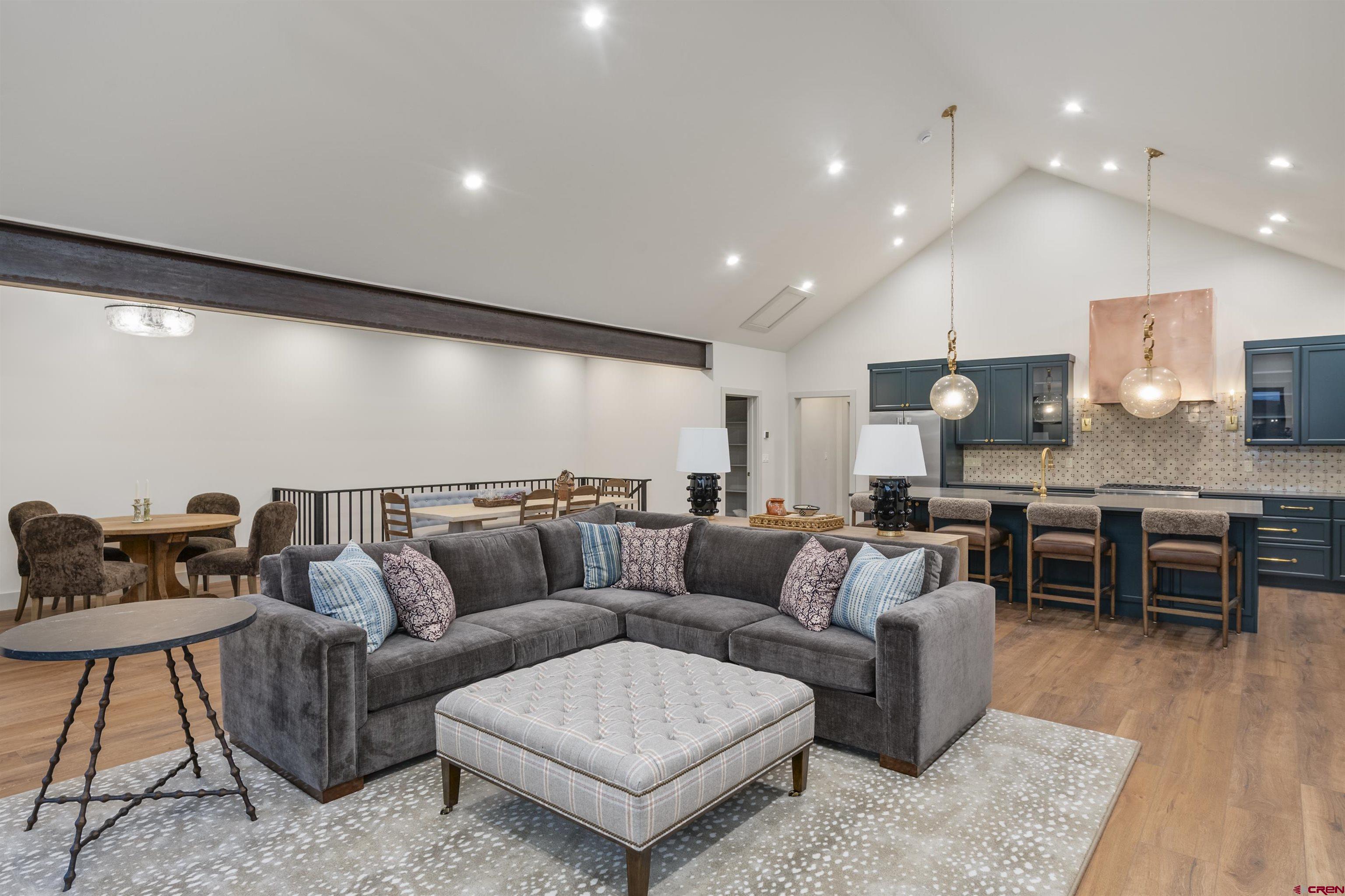 180 Elk Valley Road, Unit 118 Crested Butte, CO 81224 - Photo 2 of 39 a living room with furniture kitchen view and a wooden floor